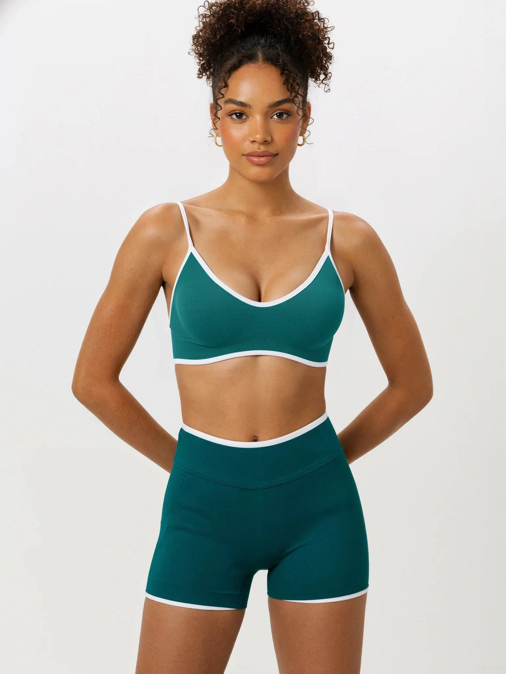 Front view of green Elevate Seamless Thin Strap Sports Bra Top with high-waisted shorts, offering a flattering fit for active lifestyles.