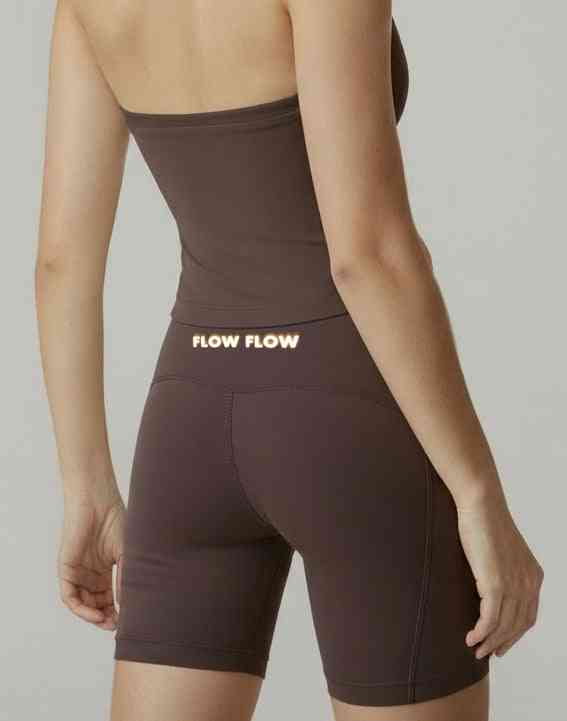 Dark brown High-Waist Biker Shorts with 'FLOW FLOW' branding on waistband, offering tummy control and a sleek activewear silhouette.
