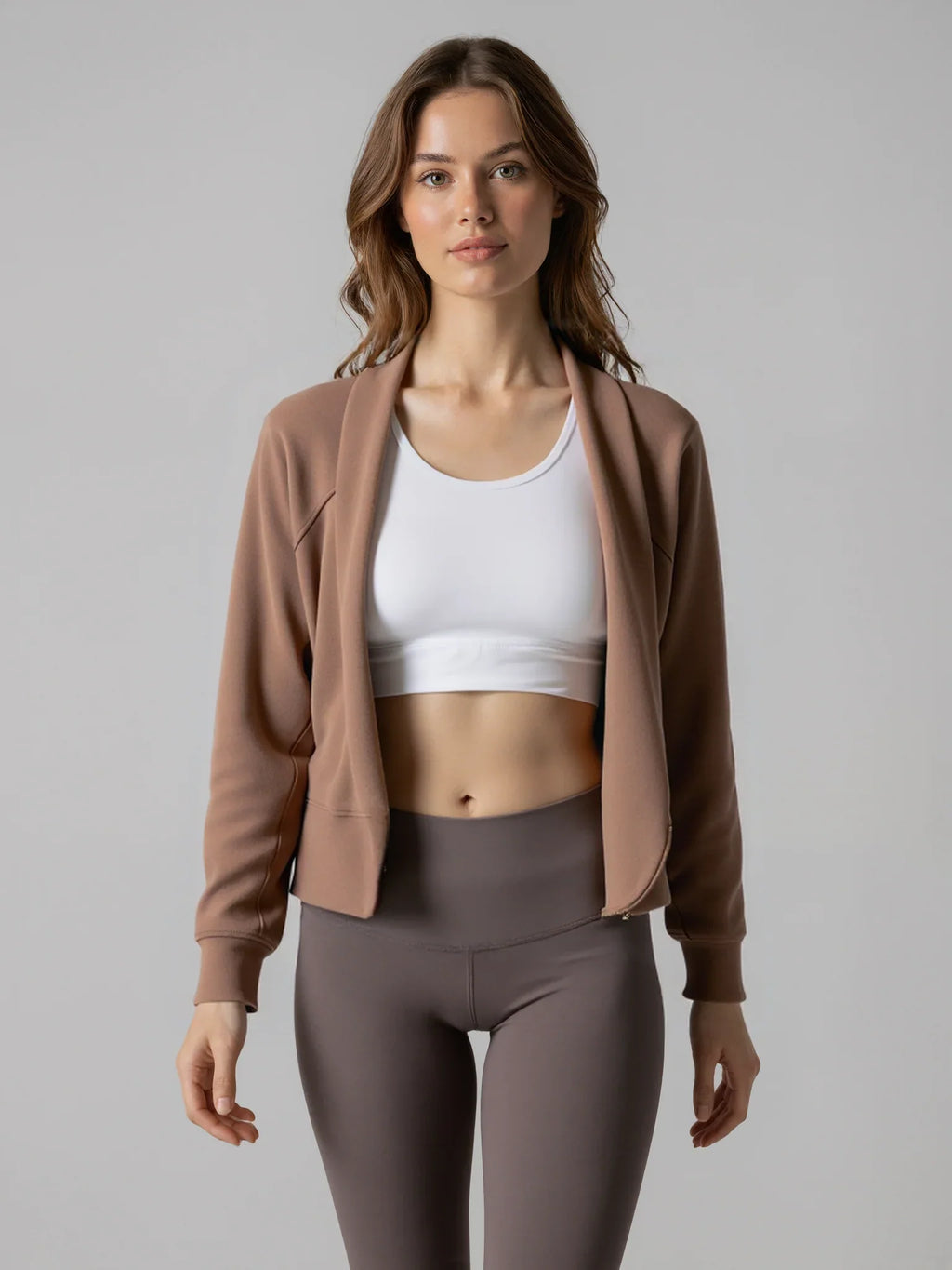 Front view of The Cloud Modal Cardigan in mocha brown, worn with a white crop top and mauve leggings for a sleek activewear outfit.