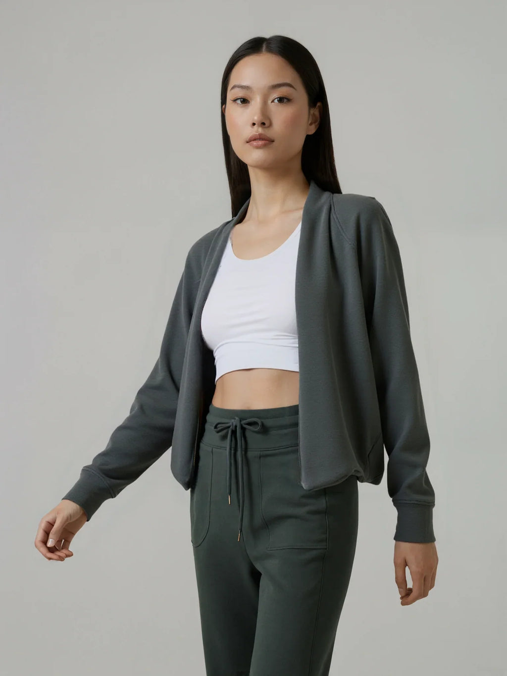 The Cloud Modal Cardigan in charcoal gray, styled with matching drawstring pants and a white crop top for a coordinated athleisure set.