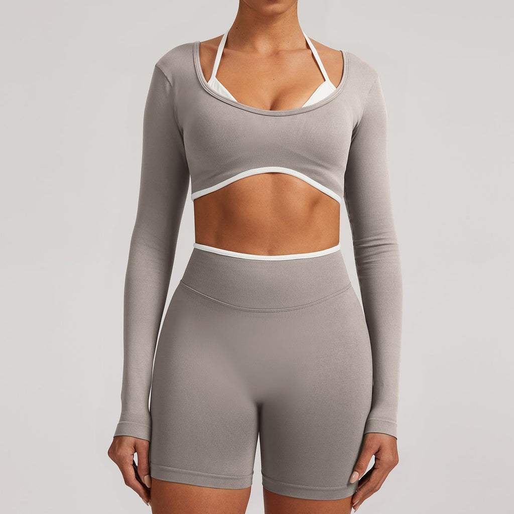 Gray Elevate Seamless Long Sleeve & Thin Strap Sports Bra Top with white contrast straps, paired with matching shorts for a minimal activewear set.