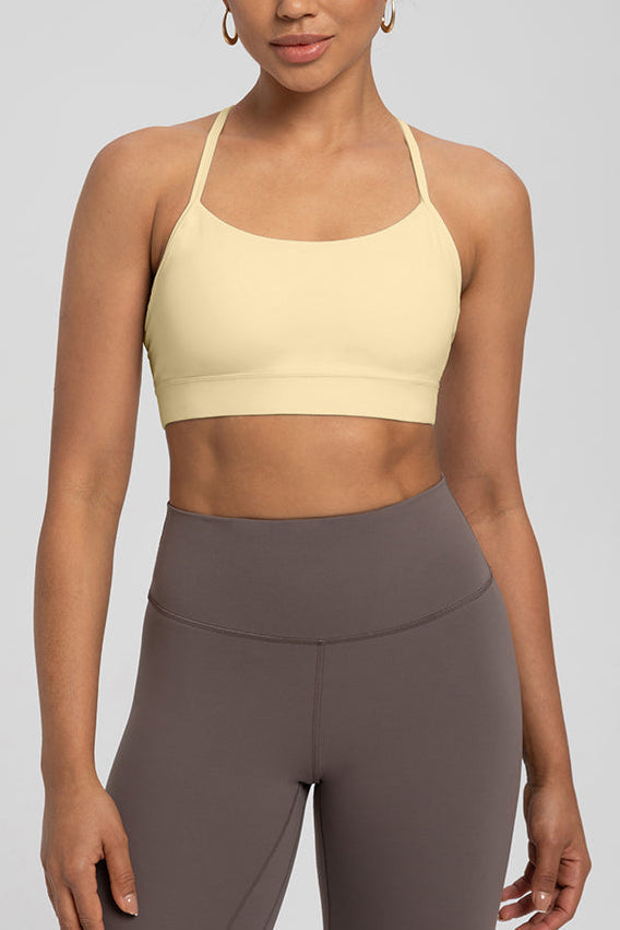 Comfort Zone Thin Strap Sports Bra Top in light yellow with 4-way stretch Lycra, offering medium support and sleek fit for activewear use.