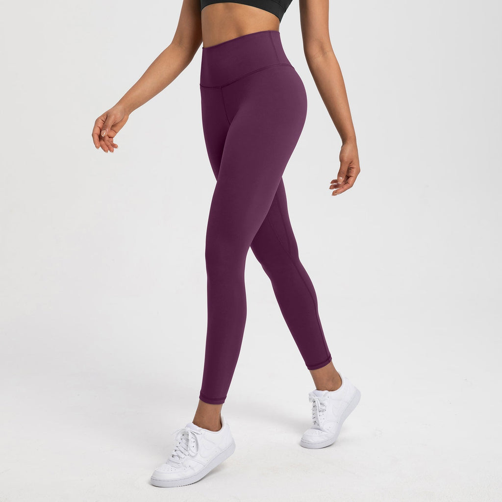 Plum purple high-waist Lycra leggings for yoga and Pilates, featuring a sleek design and supportive waistband for activewear flexibility.