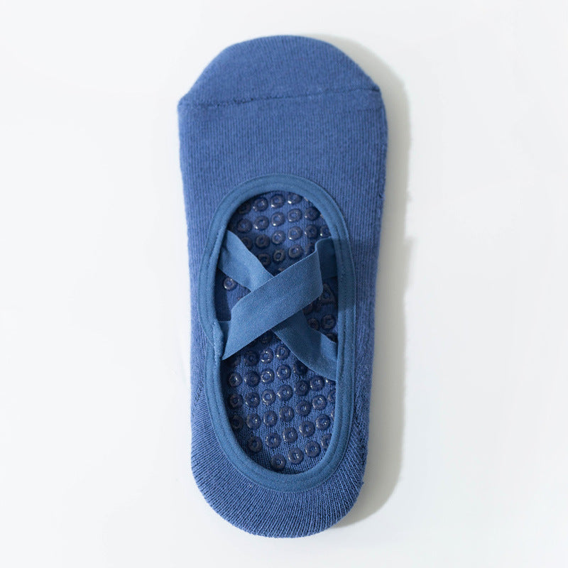 Cross-strap yoga sock in blue with 3D non-slip grip sole. Breathable, sweat-absorbent fabric ideal for stability during workouts.