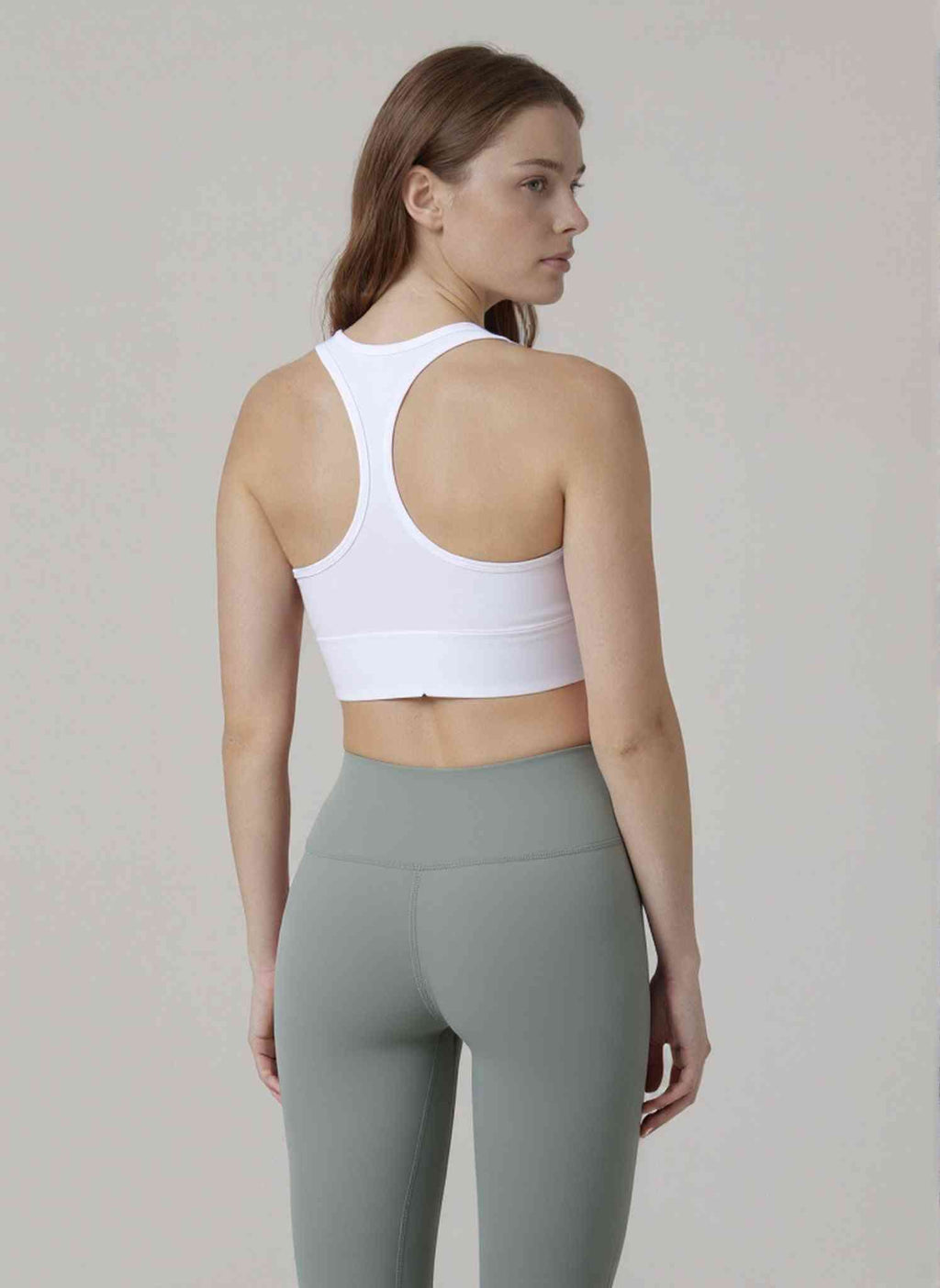 Supportive Racerback Sports Bra Top in white with sculpted back design and U-neck, ideal for confident style and full coverage support.