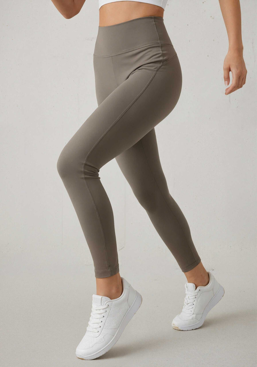 Olive High-Waist Naked Feel Lycra Leggings styled with white sneakers, perfect for activewear and daily workouts.